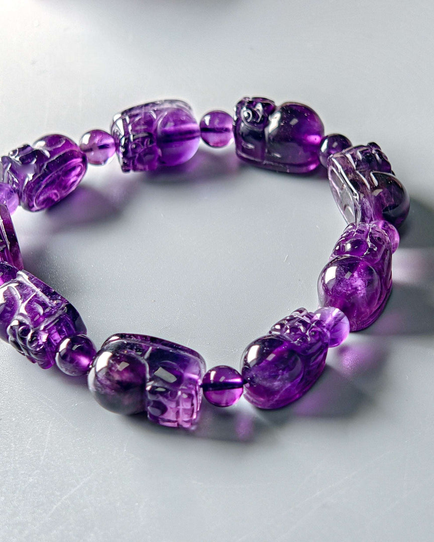 Purple beaded bracelet on a light gray background