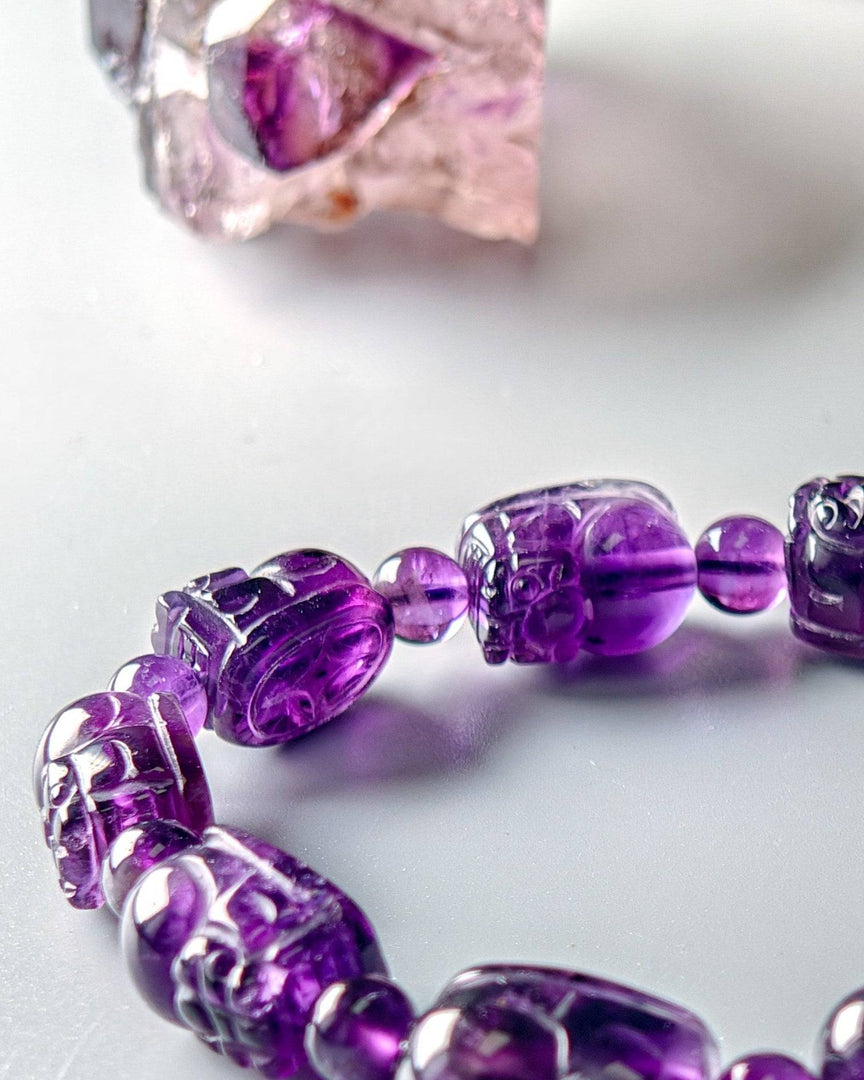 Purple beaded bracelet on a white background