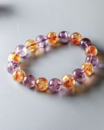 Load image into Gallery viewer, Multicolored beaded bracelet on a light gray background