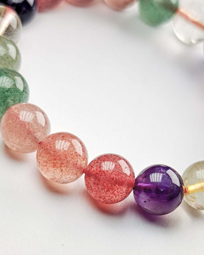 Close-up of a bracelet with multicolored beads on a white background