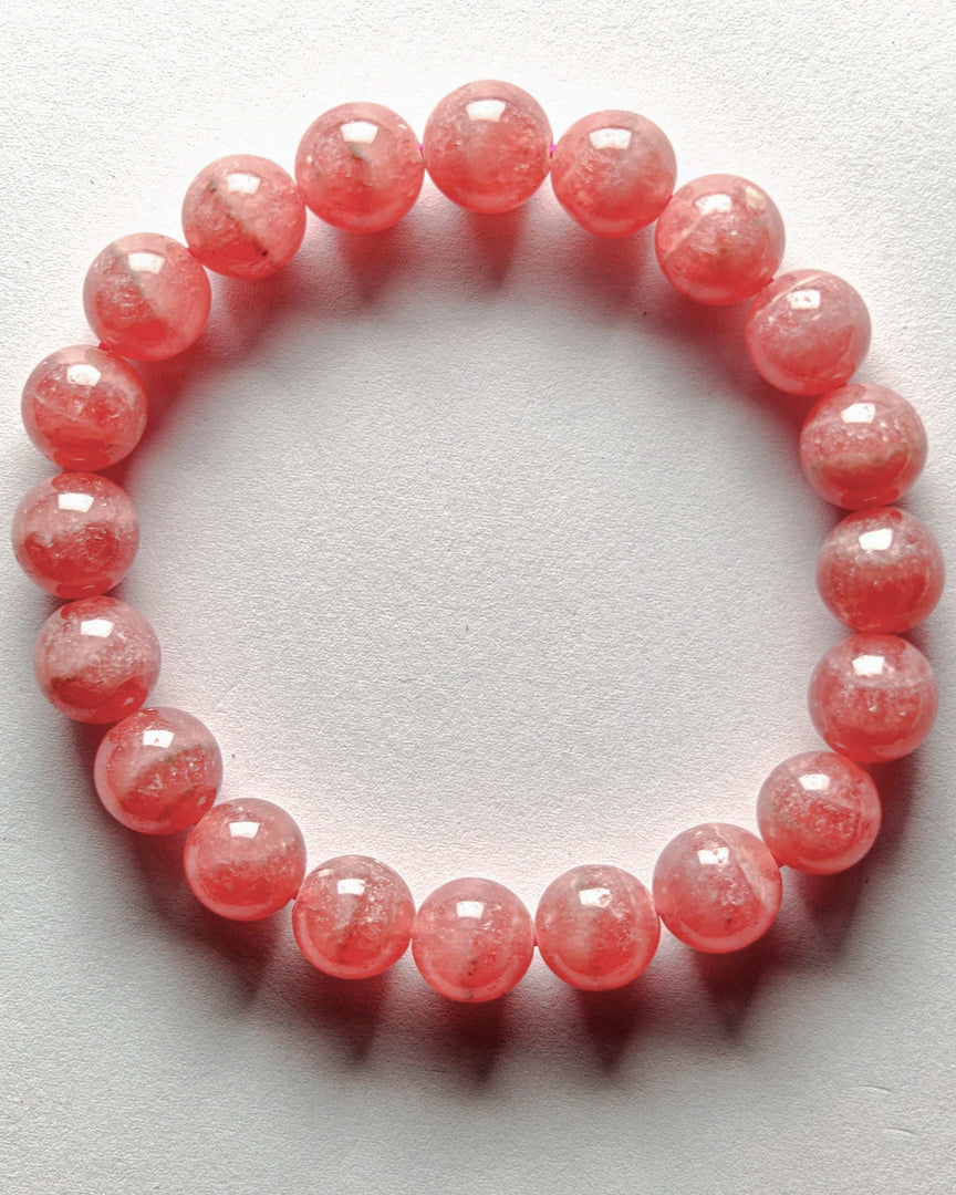 Pink beaded bracelet on a white background