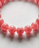 Load image into Gallery viewer, Close-up of a pink beaded bracelet on a white background