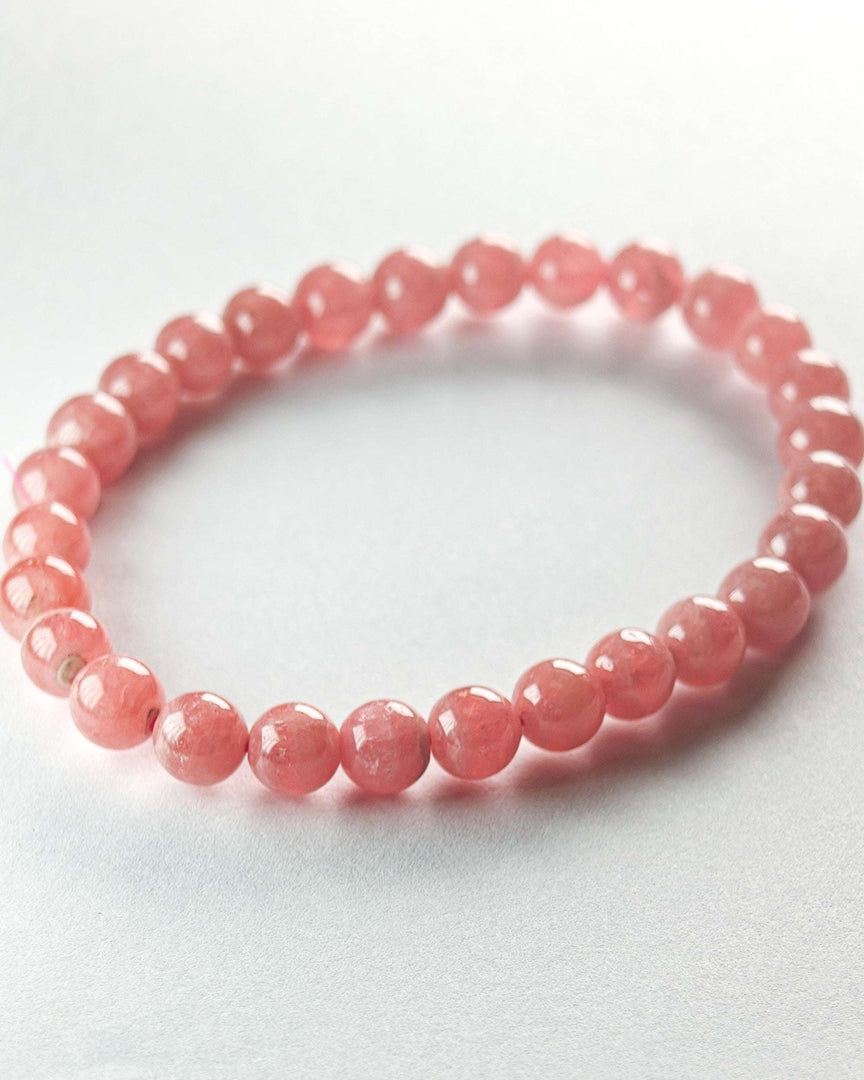 Pink beaded bracelet on a light gray background