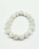 Load image into Gallery viewer, White beaded bracelet on a white background