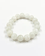 Load image into Gallery viewer, White beaded bracelet on a white background