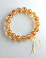 Load image into Gallery viewer, Bracelet with orange beads on a white background