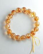 Load image into Gallery viewer, Bracelet with orange beads on a white background