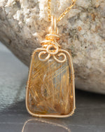 Load image into Gallery viewer, small trapezoid golden rutilated quartz pendant
