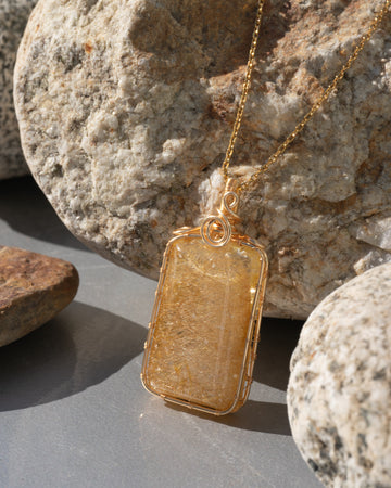 large golden rutilated quartz amulet pendant