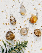 Load image into Gallery viewer, round golden rutilated quartz pendant in silver setting
