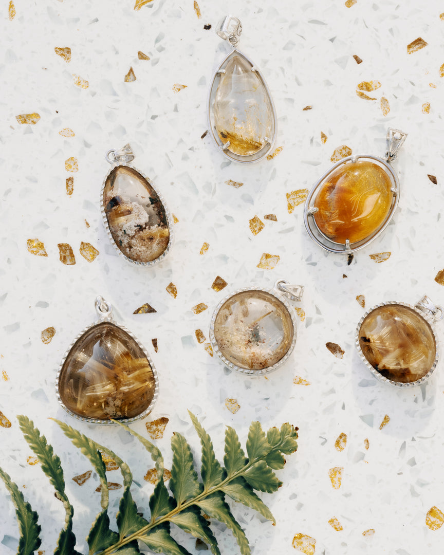 round golden rutilated quartz pendant in silver setting