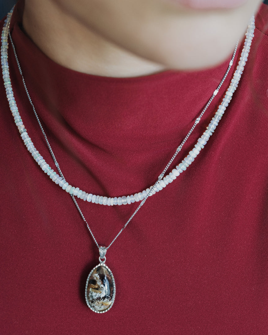 oval golden rutilated quartz pendant in silver setting