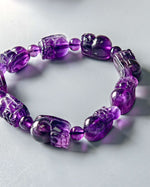 Load image into Gallery viewer, Purple beaded bracelet on a light gray background
