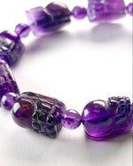 Load image into Gallery viewer, Purple beaded bracelet on a white background
