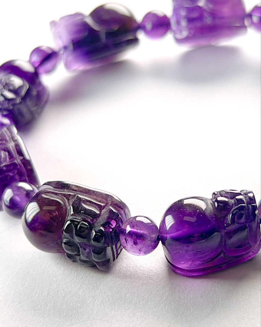 Purple beaded bracelet on a white background