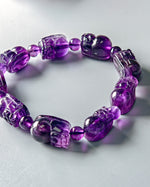 Load image into Gallery viewer, Purple beaded bracelet on a light gray background
