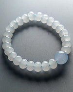 Load image into Gallery viewer, Beaded bracelet with a single blue gemstone on a gray background