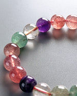 Load image into Gallery viewer, Close-up of a bracelet with multicolored beads on a gray background
