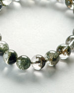 Load image into Gallery viewer, Close-up of Green Phantom Quartz Bracelet (Light Inclusion) on a light background
