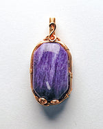 Load image into Gallery viewer, Purple stone pendant with gold wire wrapping on a white background
