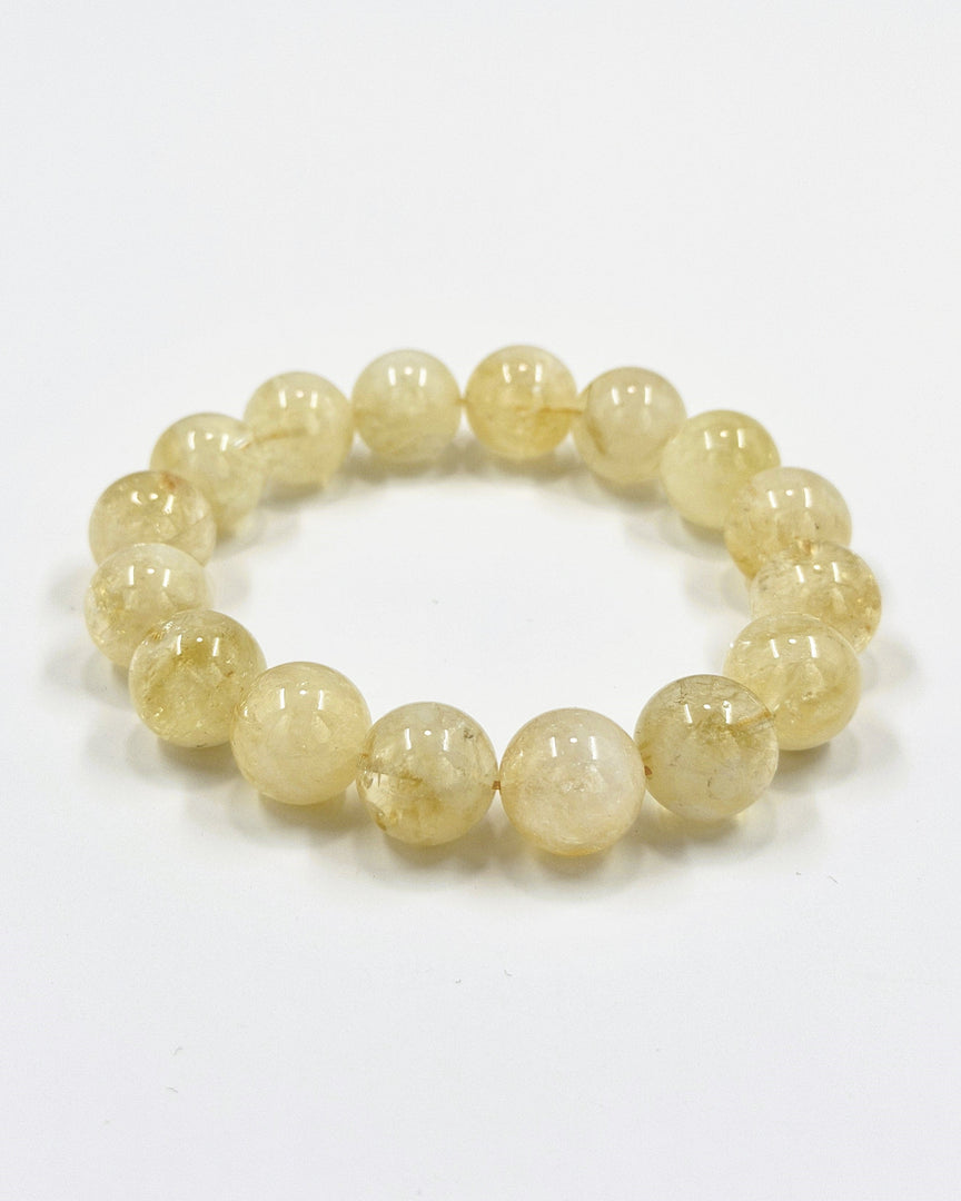 Yellow beaded bracelet on a white background