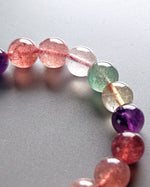 Load image into Gallery viewer, Close-up of a bracelet with multicolored beads on a gray background
