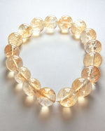 Load image into Gallery viewer, Bracelet with yellow beads on a light gray background
