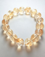 Load image into Gallery viewer, Bracelet with yellow beads on a light gray background
