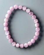 Load image into Gallery viewer, Pink beaded bracelet on a gray background
