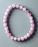 Load image into Gallery viewer, Pink beaded bracelet on a gray background
