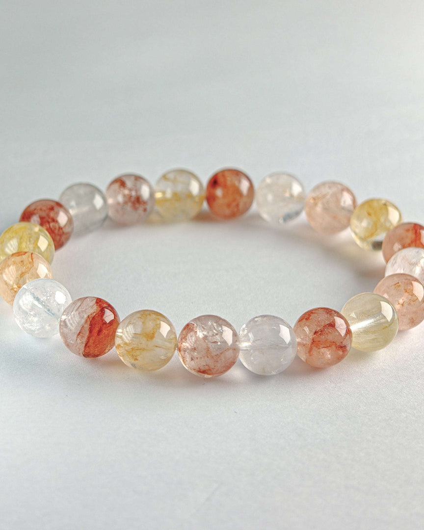 Beaded bracelet with multicolored beads on a light gray background