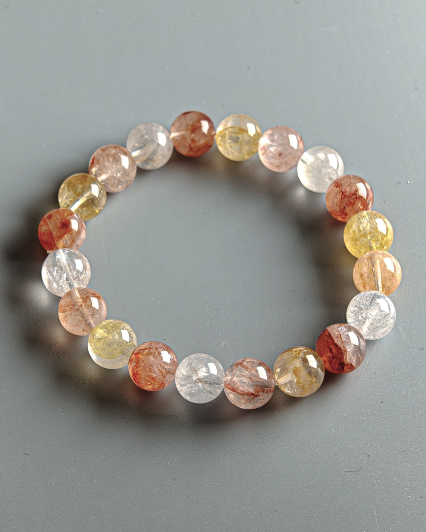 Multicolored beaded bracelet on a gray background