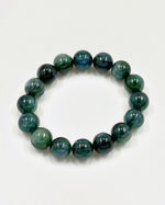 Load image into Gallery viewer, A beaded stretch bracelet made of polished round beads in shades of green and blue with natural marbled patterns, displayed on a clean white background.