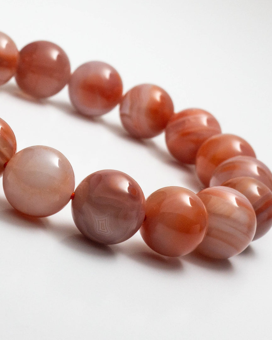 Necklace with pink marbled beads on a white background
