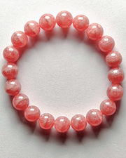 Pink beaded bracelet on a white background