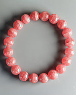Load image into Gallery viewer, Pink beaded bracelet on a gray background
