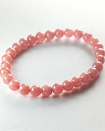 Load image into Gallery viewer, Pink beaded bracelet on a light gray background

