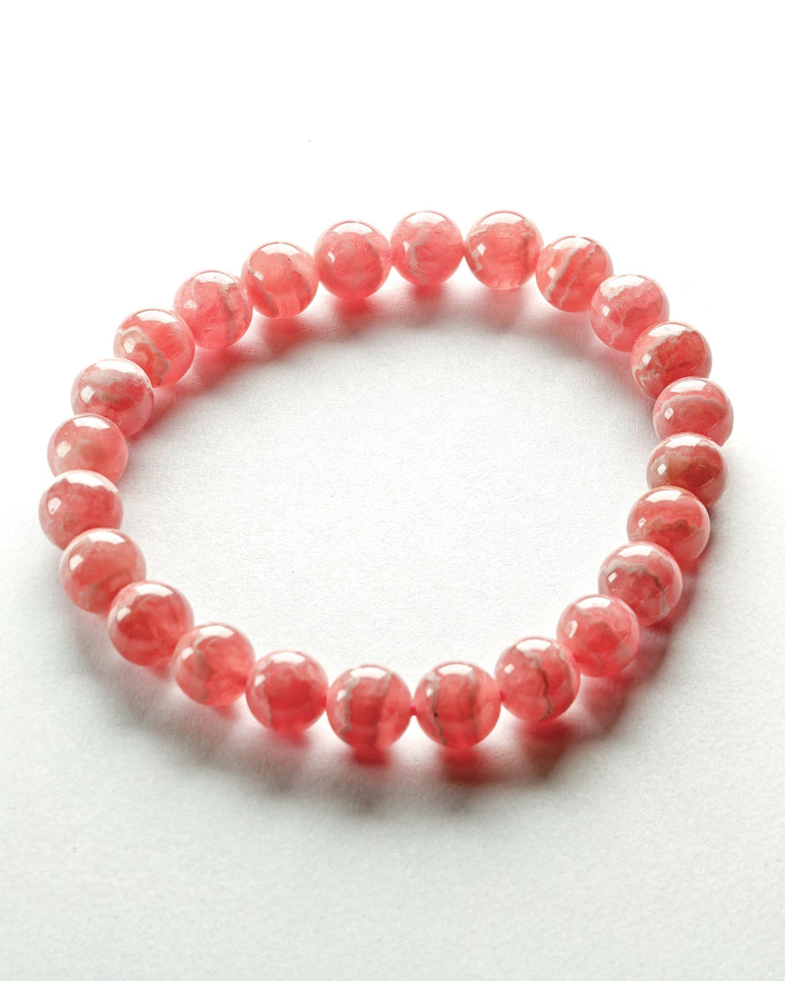 Pink beaded bracelet on a white background