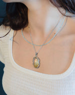 Load image into Gallery viewer, “rabbit hair” quartz pendant in silver setting
