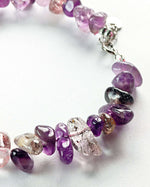 Load image into Gallery viewer, Close-up of a bracelet with purple and pink gemstones on a white background
