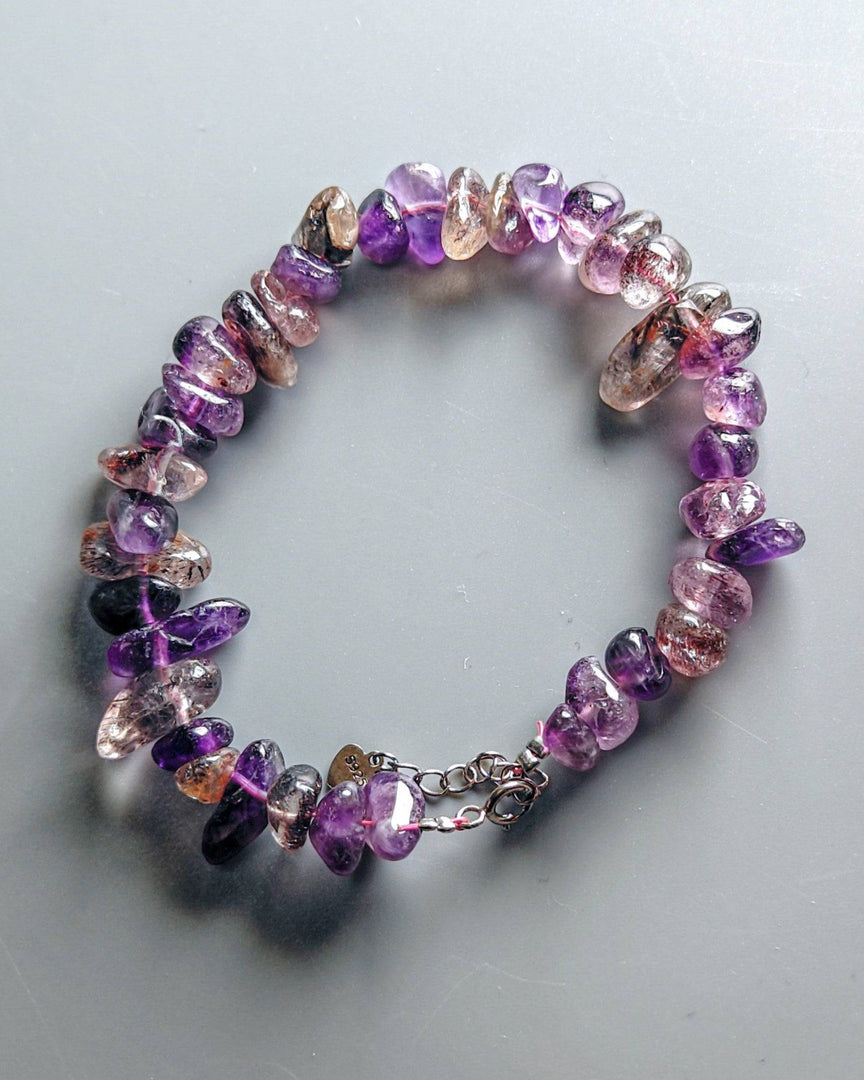 Multicolored beaded bracelet on a light gray background