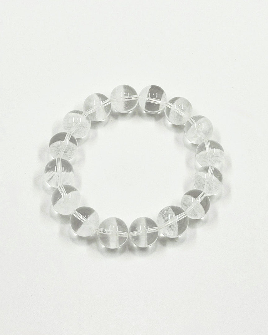 Clear beaded bracelet on a light gray background
