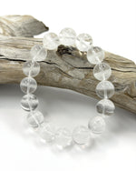 Load image into Gallery viewer, Clear beaded bracelet on a wooden branch with a white background