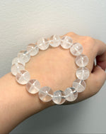 Load image into Gallery viewer, Clear beaded bracelet on a wrist against a neutral background