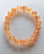 Load image into Gallery viewer, Orange beaded bracelet on a light gray background
