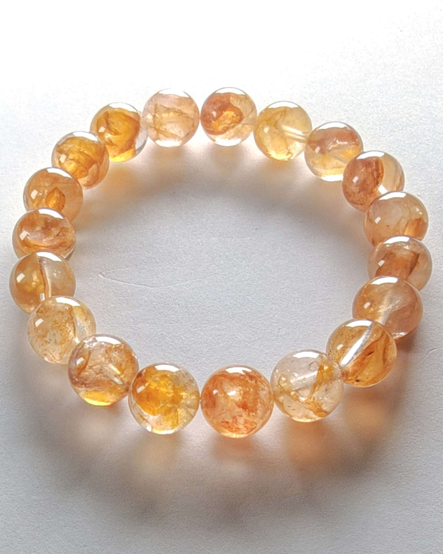 Orange beaded bracelet on a white background