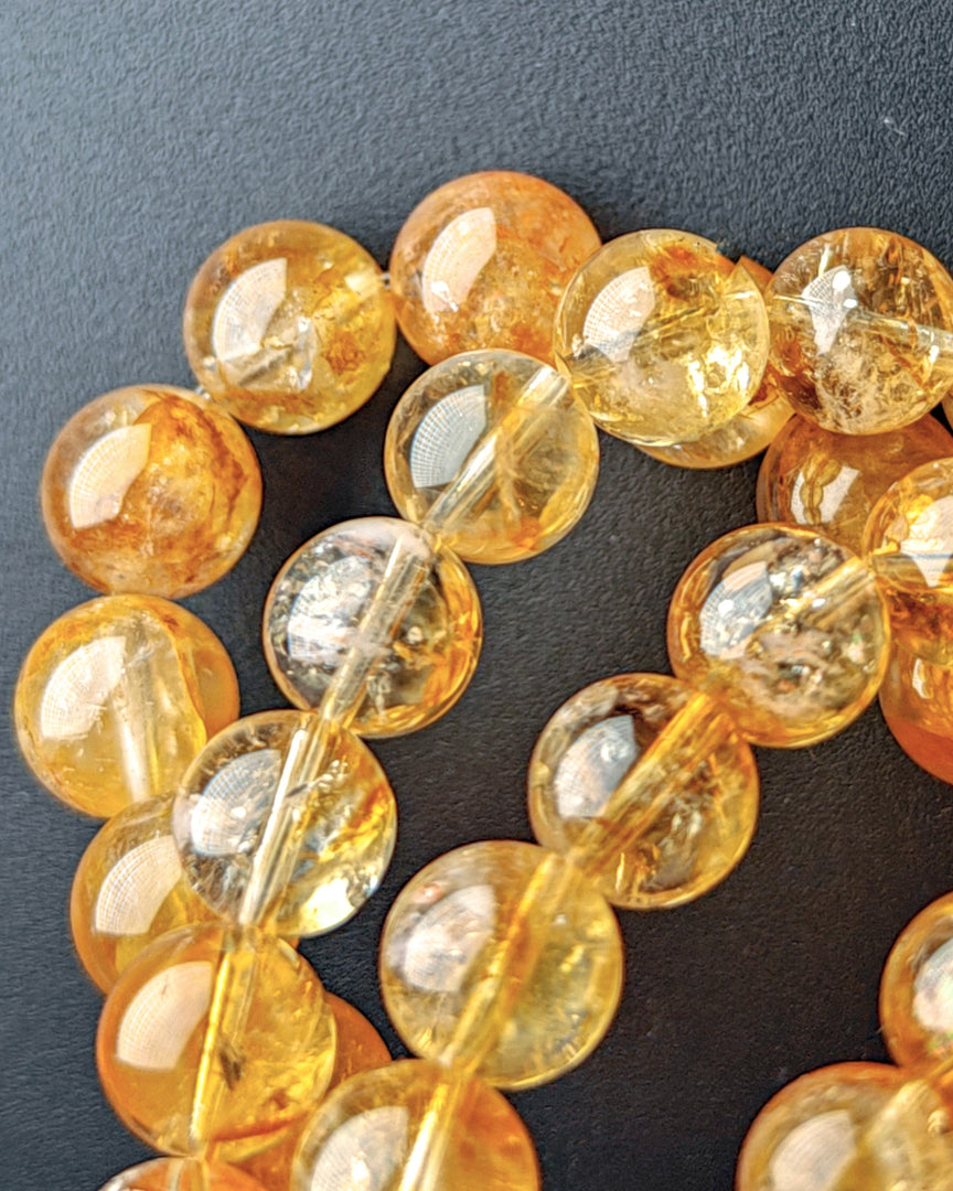 Close-up of amber-colored beads on a dark background