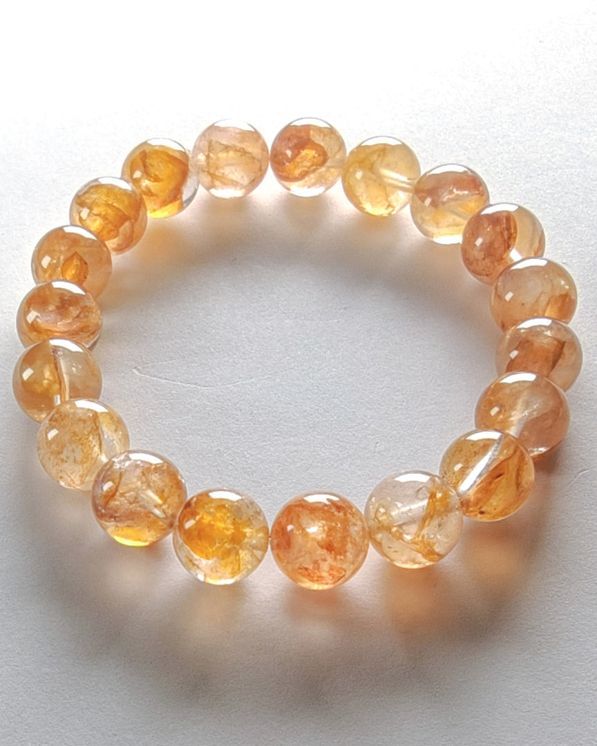Orange beaded bracelet on a white background