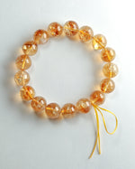 Load image into Gallery viewer, Bracelet with orange beads on a white background
