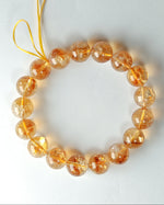 Load image into Gallery viewer, Bracelet with orange beads on a white background
